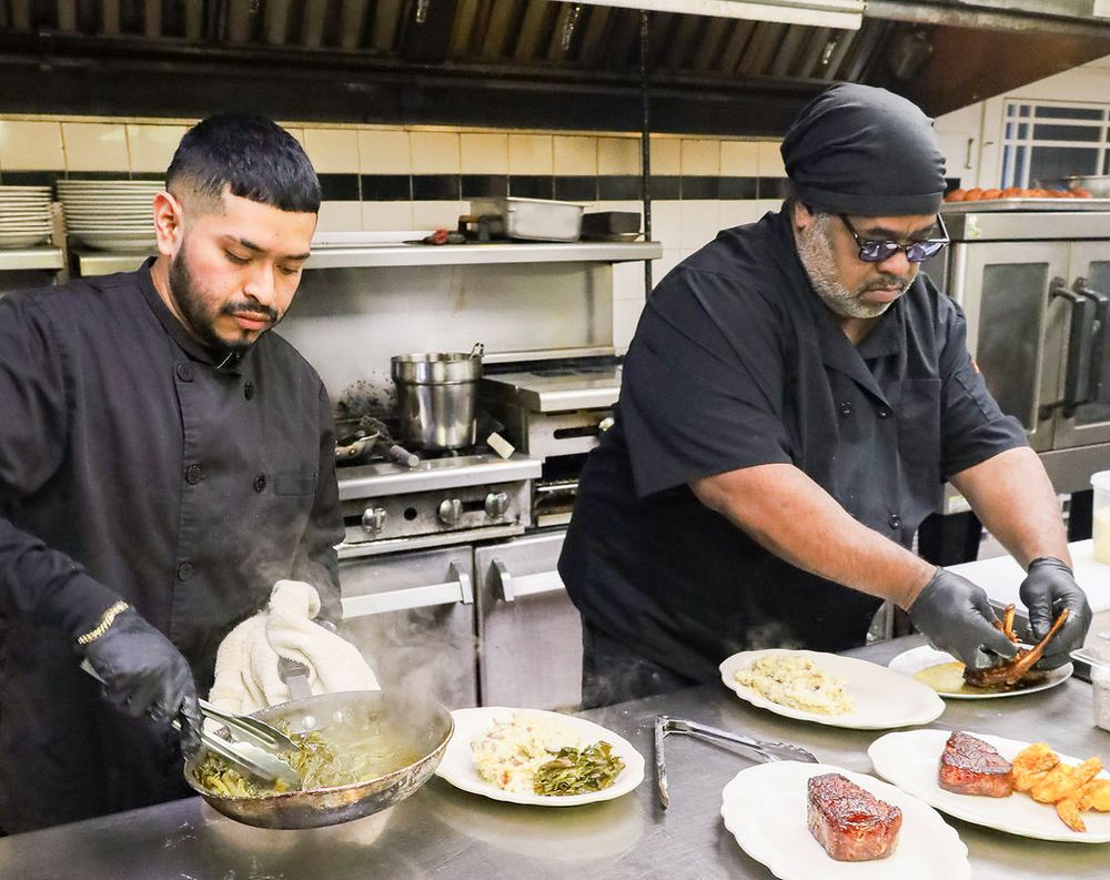 Executive Chef Raymond Allen and kitchen team plating dinner service